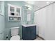 Charming bathroom with navy vanity and white fixtures, including a tub with shower at 4722 W Laurel Rd, Tampa, FL 33629