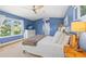 Calm bedroom with large windows, wooden floors, and a spacious layout at 4722 W Laurel Rd, Tampa, FL 33629