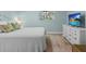 Minimal bedroom with plush bedding and a large dresser at 4722 W Laurel Rd, Tampa, FL 33629