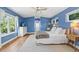 Serene bedroom with natural light, a comfortable bed, and hardwood flooring at 4722 W Laurel Rd, Tampa, FL 33629