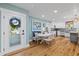 Inviting dining area with hardwood floors, ample seating, natural light, and a modern, open kitchen layout at 4722 W Laurel Rd, Tampa, FL 33629
