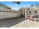 Welcoming home entrance with patterned paver driveway, cozy seating, and a convenient attached garage at 4722 W Laurel Rd, Tampa, FL 33629