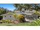 Beautiful home with a manicured lawn, lush landscaping, and a welcoming front entrance at 4722 W Laurel Rd, Tampa, FL 33629