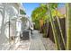 Exterior walkway with palm trees, air conditioning units, and fenced yard at 4722 W Laurel Rd, Tampa, FL 33629