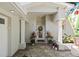 Charming front entrance featuring decorative door, wreath, colorful plants, and patterned paver porch at 4722 W Laurel Rd, Tampa, FL 33629