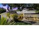 Charming home featuring mature landscaping, a paver driveway, and covered front entrance with seating at 4722 W Laurel Rd, Tampa, FL 33629