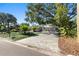 Inviting home showcasing a lush lawn, paver driveway, mature trees, and a serene neighborhood street at 4722 W Laurel Rd, Tampa, FL 33629