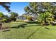 Beautiful home with manicured artificial lawn and lush palm trees creates a tropical paradise at 4722 W Laurel Rd, Tampa, FL 33629