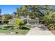 Charming home with manicured lawn, mature trees and an inviting stone driveway at 4722 W Laurel Rd, Tampa, FL 33629
