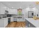 Well-equipped kitchen with white cabinets, wine rack, and stainless steel refrigerator at 4722 W Laurel Rd, Tampa, FL 33629