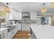 Bright kitchen with white cabinets, quartz countertops, and stainless steel appliances at 4722 W Laurel Rd, Tampa, FL 33629