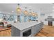 Open kitchen showcasing pendant lighting, a large island and stainless steel appliances at 4722 W Laurel Rd, Tampa, FL 33629
