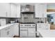 Kitchen featuring white cabinetry, stainless steel appliances and a tile backsplash at 4722 W Laurel Rd, Tampa, FL 33629