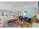 Bright living room with hardwood floors, a cozy fireplace, and an open floor plan at 4722 W Laurel Rd, Tampa, FL 33629