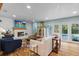 Cozy living room features fireplace, hardwood floors, and French doors leading to outdoor pool at 4722 W Laurel Rd, Tampa, FL 33629