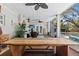Spacious covered patio with a large dining table and comfortable seating area at 4722 W Laurel Rd, Tampa, FL 33629