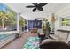 Inviting outdoor patio with comfortable seating, a ceiling fan, and lush greenery at 4722 W Laurel Rd, Tampa, FL 33629