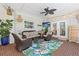 Relaxing outdoor patio with wicker furniture, plants, and overhead lighting at 4722 W Laurel Rd, Tampa, FL 33629