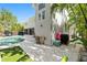 Backyard pool area with table and chairs, lush tropical landscaping, and home exterior at 4722 W Laurel Rd, Tampa, FL 33629