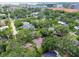 A charming neighborhood with lush landscaping and a mix of single-Gathering homes is captured from an aerial view at 5107 W Azeele St, Tampa, FL 33609