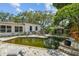 Lush backyard with a unique pool ready for renovation, surrounded by greenery at 5107 W Azeele St, Tampa, FL 33609