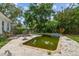 Lush backyard with a unique pool ready for renovation surrounded by a brick patio at 5107 W Azeele St, Tampa, FL 33609