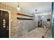 Basement featuring brick walls, wooden shelving, painted ceiling, and access doors at 5107 W Azeele St, Tampa, FL 33609