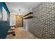 Basement featuring brick walls, wooden shelving, painted ceiling, and access doors at 5107 W Azeele St, Tampa, FL 33609