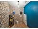 Unfinished basement with brick accent wall and new water heater at 5107 W Azeele St, Tampa, FL 33609