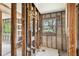 Unfinished bathroom with wood framing, window and tile flooring at 5107 W Azeele St, Tampa, FL 33609