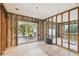 Bedroom ready for renovation with sliding glass door leading to the exterior at 5107 W Azeele St, Tampa, FL 33609