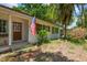 The front exterior features a brick facade, updated windows, and beautiful landscaping at 5107 W Azeele St, Tampa, FL 33609