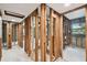 Interior view of home in progress with wood framing, white floors, and bathroom features at 5107 W Azeele St, Tampa, FL 33609