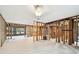 Large living room with exposed framing, new flooring, and an open layout, ready for customization at 5107 W Azeele St, Tampa, FL 33609
