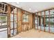 Spacious living room with wood frame structure, block walls, windows, and unfinished wood-look flooring at 5107 W Azeele St, Tampa, FL 33609