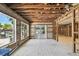Bright sunroom featuring tile floors, exposed rafters, large windows overlooking the backyard, and an outdoor patio entrance at 5107 W Azeele St, Tampa, FL 33609