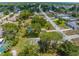 Aerial view of a home with a landscaped yard and mature trees at 5112 Odin St, Spring Hill, FL 34608