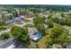 Aerial view of a home with a screened pool and a playground at 5112 Odin St, Spring Hill, FL 34608