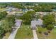 Aerial view of a home with a detached garage and landscaped yard at 5112 Odin St, Spring Hill, FL 34608