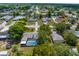 Aerial view of a home with a screened pool and a large backyard at 5112 Odin St, Spring Hill, FL 34608