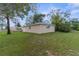 A large backyard view showcases the home's exterior and a well-maintained lawn at 5112 Odin St, Spring Hill, FL 34608