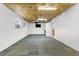 A finished basement provides an open space, complete with carpet tiles and a TV at 5112 Odin St, Spring Hill, FL 34608