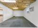 A finished basement offers a large space with carpet tiles, windows, and an AC unit at 5112 Odin St, Spring Hill, FL 34608