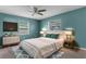 Cozy bedroom with blue walls features a bed, dresser, and complementary decor at 5112 Odin St, Spring Hill, FL 34608