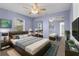 Modern bedroom with a comfortable bed, sleek furniture, and a wall-mounted TV at 5112 Odin St, Spring Hill, FL 34608