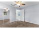 Bedroom with neutral walls, carpet floor, ceiling fan, closet, and outdoor access at 5112 Odin St, Spring Hill, FL 34608