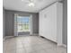 Bedroom with tiled floor features a murphy bed and natural light from a window at 5112 Odin St, Spring Hill, FL 34608