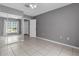 Bedroom boasts a tiled floor, mirrored closet, and modern gray walls at 5112 Odin St, Spring Hill, FL 34608