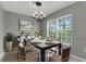 Bright dining room with a white table set for lunch, complemented by stylish light fixtures at 5112 Odin St, Spring Hill, FL 34608