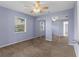 A basic bedroom with a neutral color scheme, carpeted floor, and built in mirrored closet at 5112 Odin St, Spring Hill, FL 34608